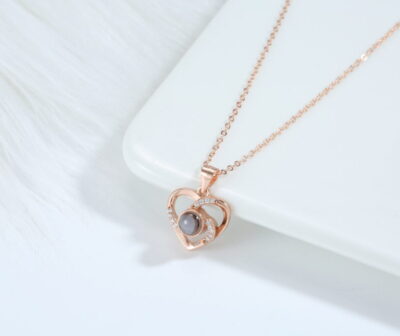 Love Link rose gold necklace featuring interlocking hearts with luminous pearl centre