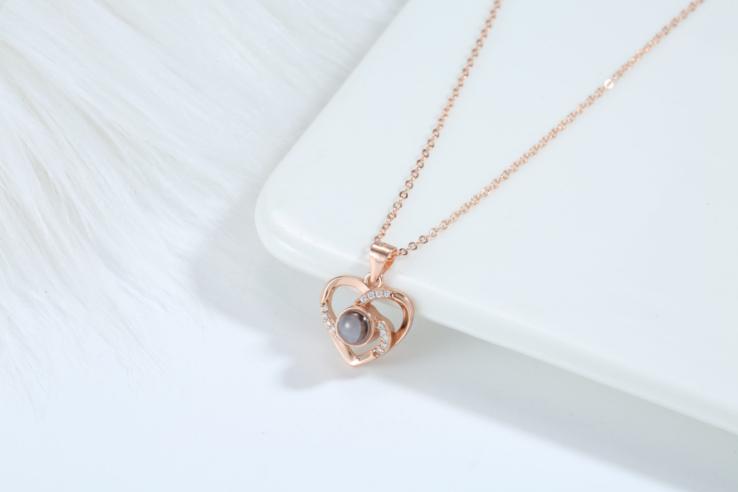 Love Link rose gold necklace featuring interlocking hearts with luminous pearl centre