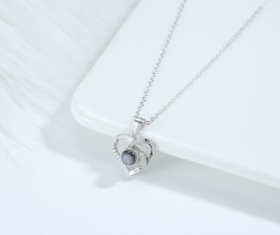 Love Link silver necklace featuring interlocking hearts with luminous pearl centre